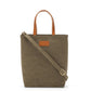 A washable paper rectangular tote with long top handles and a long shoulder strap is shown from the front angle. It is khaki in colour.