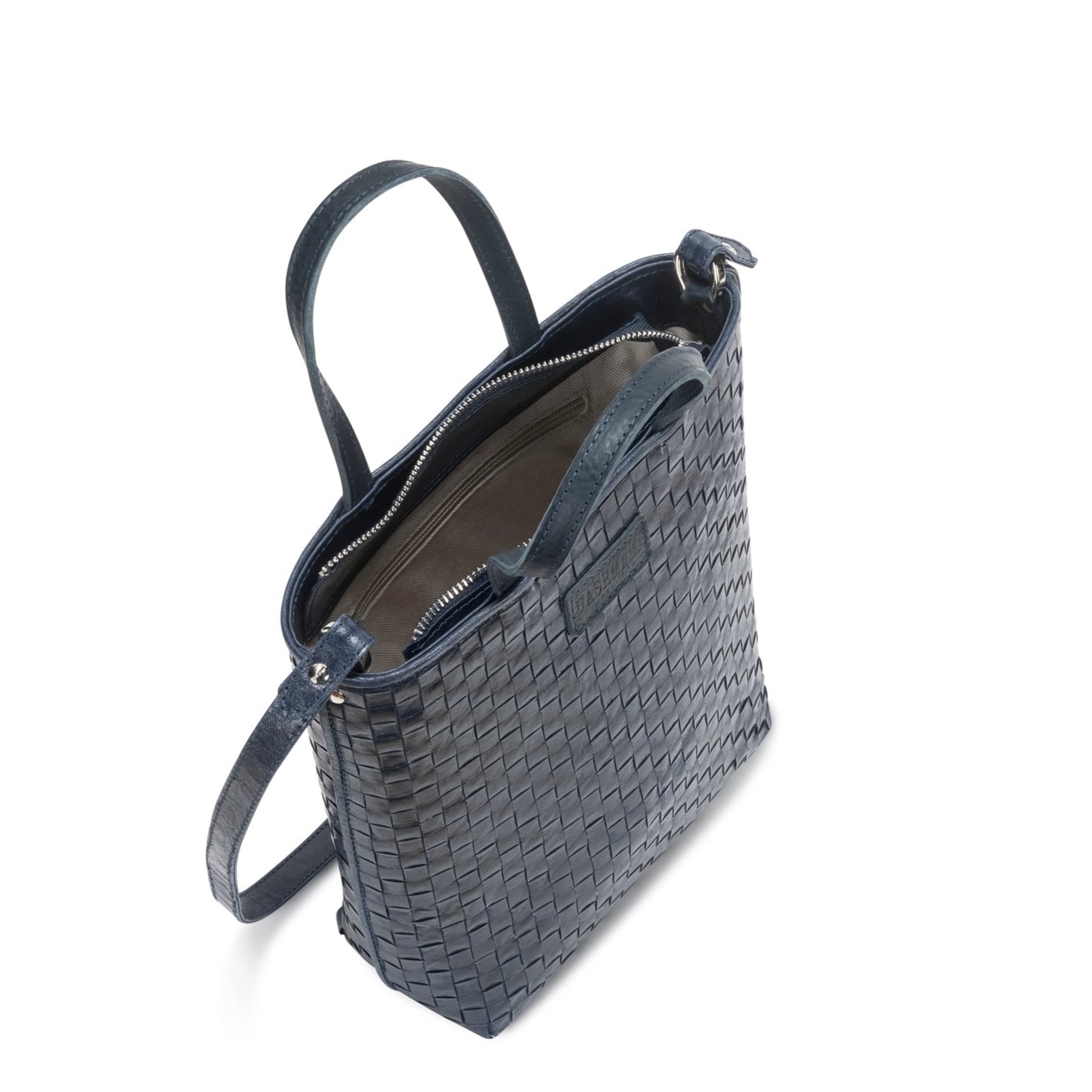 A woven washable paper tote bag is shown from a top-down angle, unzipped to reveal an inside zip pocket. It is navy in colour.
