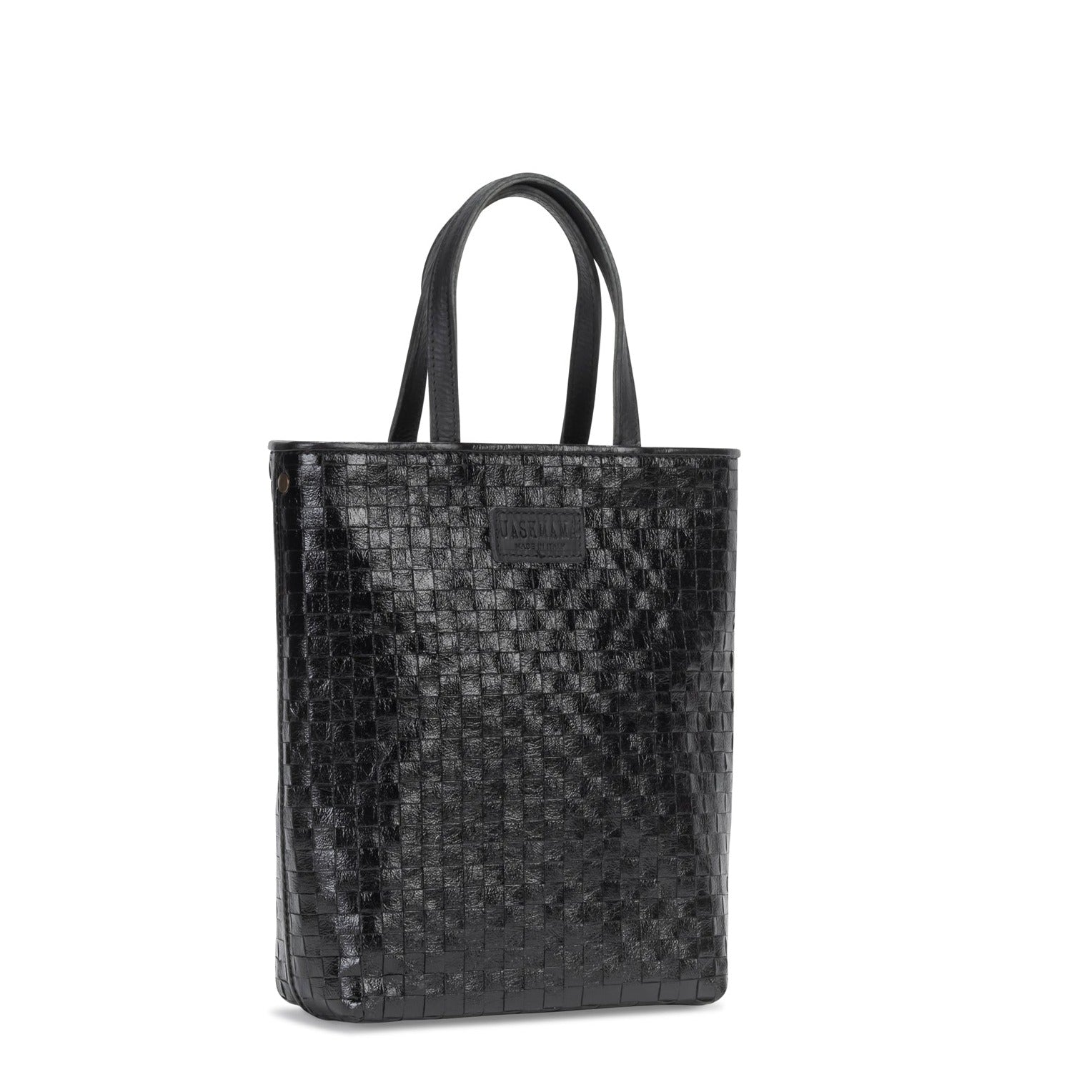 A woven washable tote bag is shown from a 3/4 angle. It has two top handles and is black in colour.