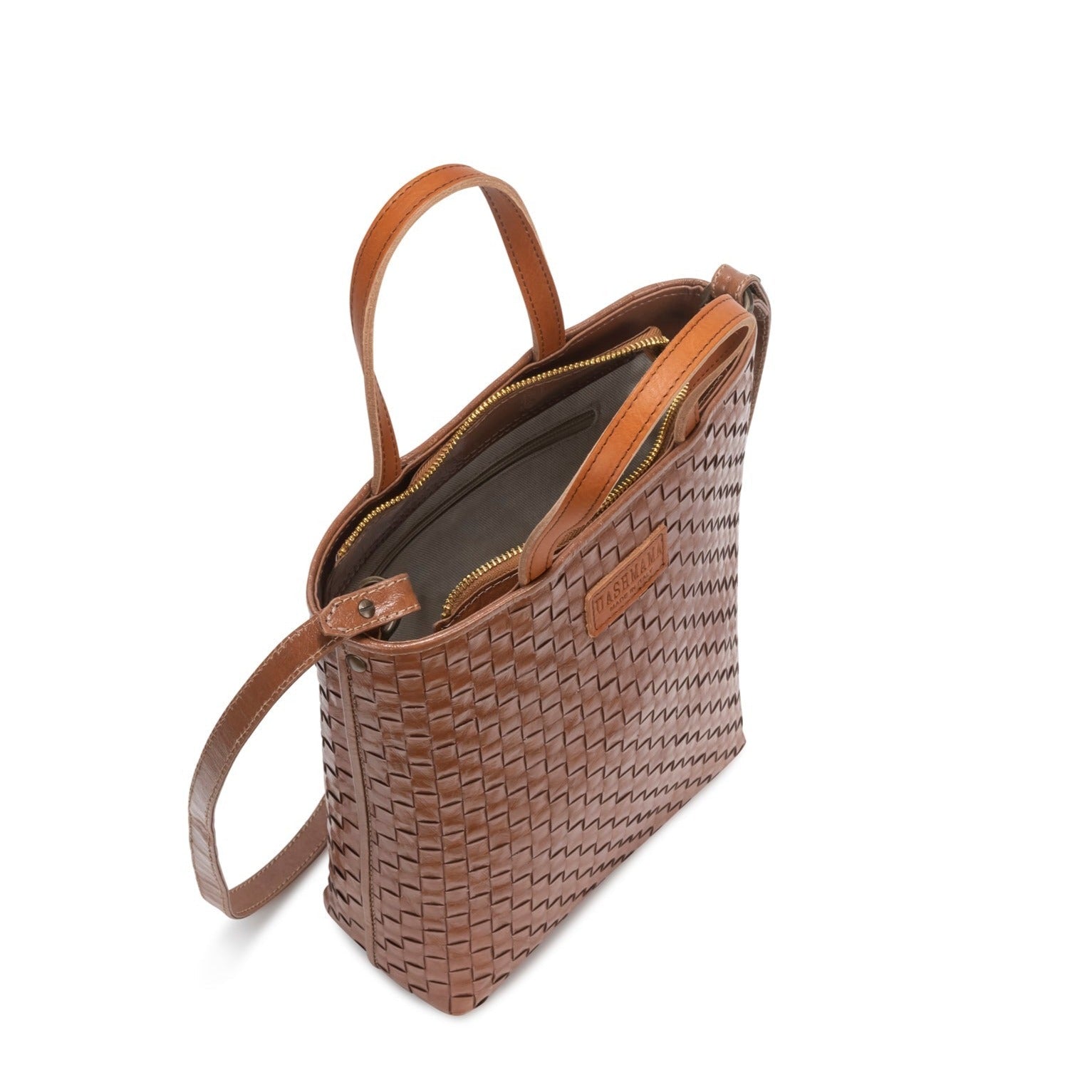 A woven washable paper tote bag is shown from a top-down angle, unzipped to reveal an inside zip pocket. It is brown in colour.