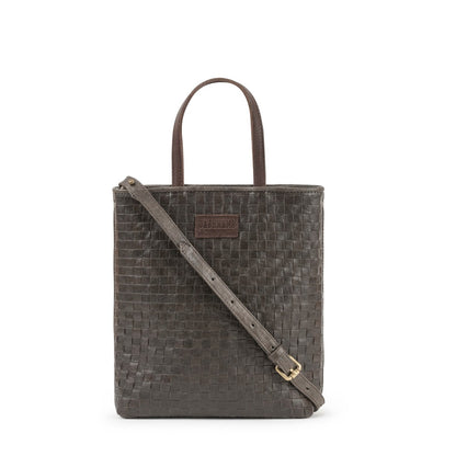 A woven washable paper tote bag is shown from the front angle. It has two top handles and a long shoulder strap. It is grey-brown in colour.