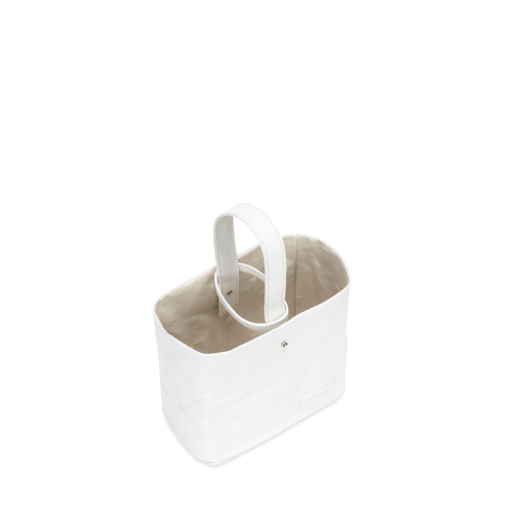 A washable paper utensil holder is shown from a top down angle. It features a top handle and a cotton lining, and it is white in colour. 