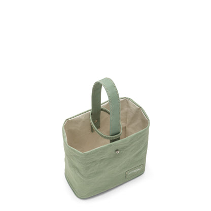 A washable paper utensil holder is shown from a top down angle. It features a top handle and a cotton lining, and it is green in colour. 