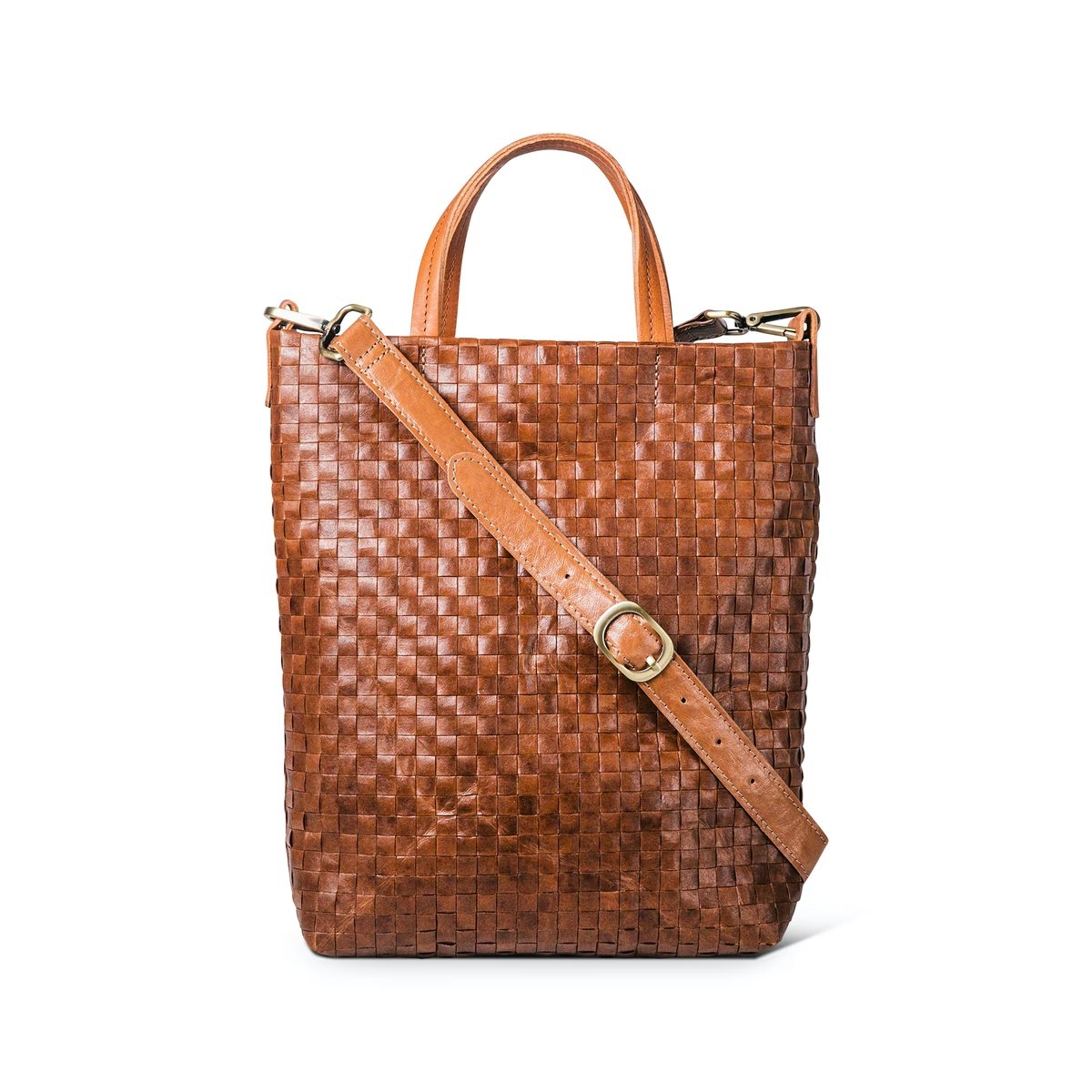 A woven washable paper tote bag is shown from the front angle. It features two top handles and a long adjustable shoulder strap. It is brown in colour.