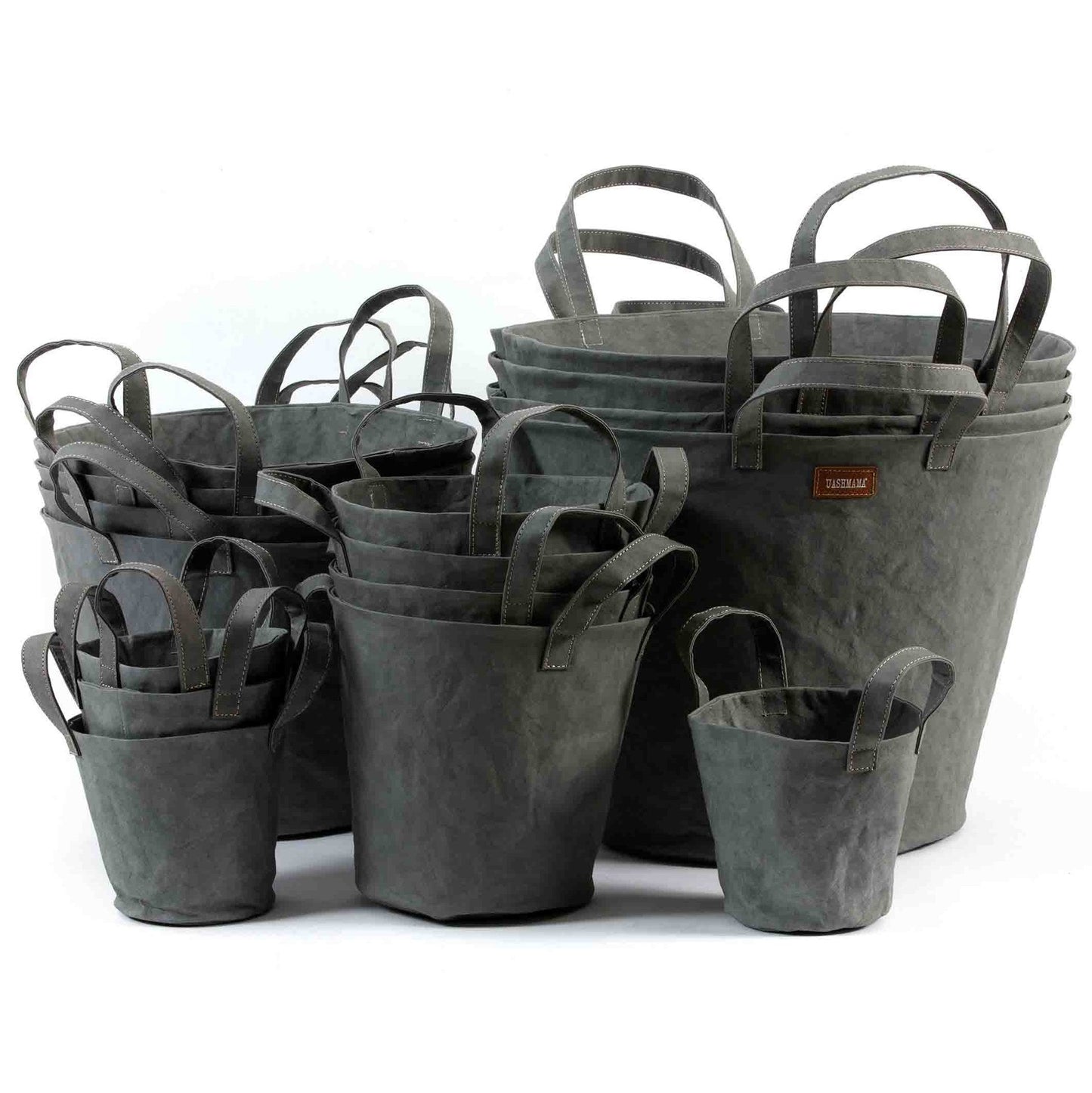 A selection of washable paper baskets are shown stacked in one another, in four varying sizes. They are shown in a dark grey colour.