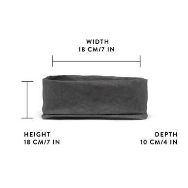 A washable paper tray is shown from a side angle. It is rectangular in shape and charcoal in colour. It shows a graphic displaying its measurements - 18cm wide x 18cm high x 10cm deep.