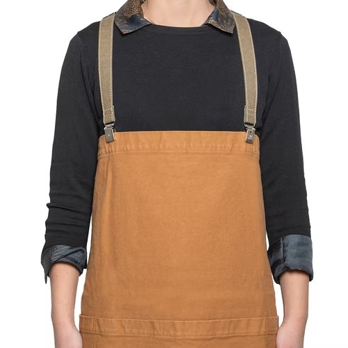 A person is shown wearing a black long-sleeved t-shirt and a washable paper apron with washable paper and metal clip straps. The apron is tan in colour.