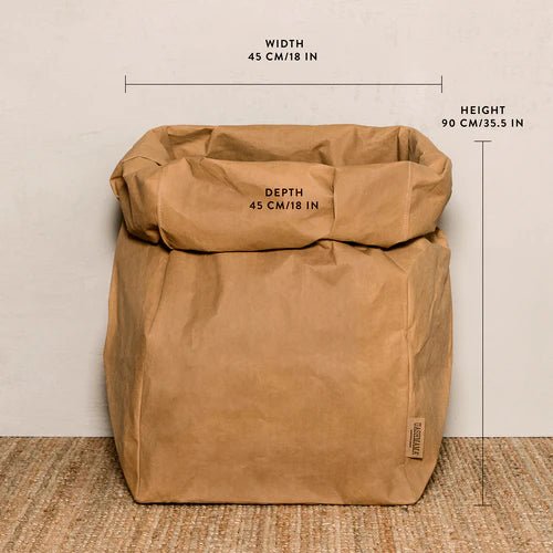 A washable paper bag is shown. The bag is rolled down at the top and features a UASHMAMA logo label on the bottom left corner. The bag pictured is the gigantic size in tan. The dimensions of the bag are shown on the image.