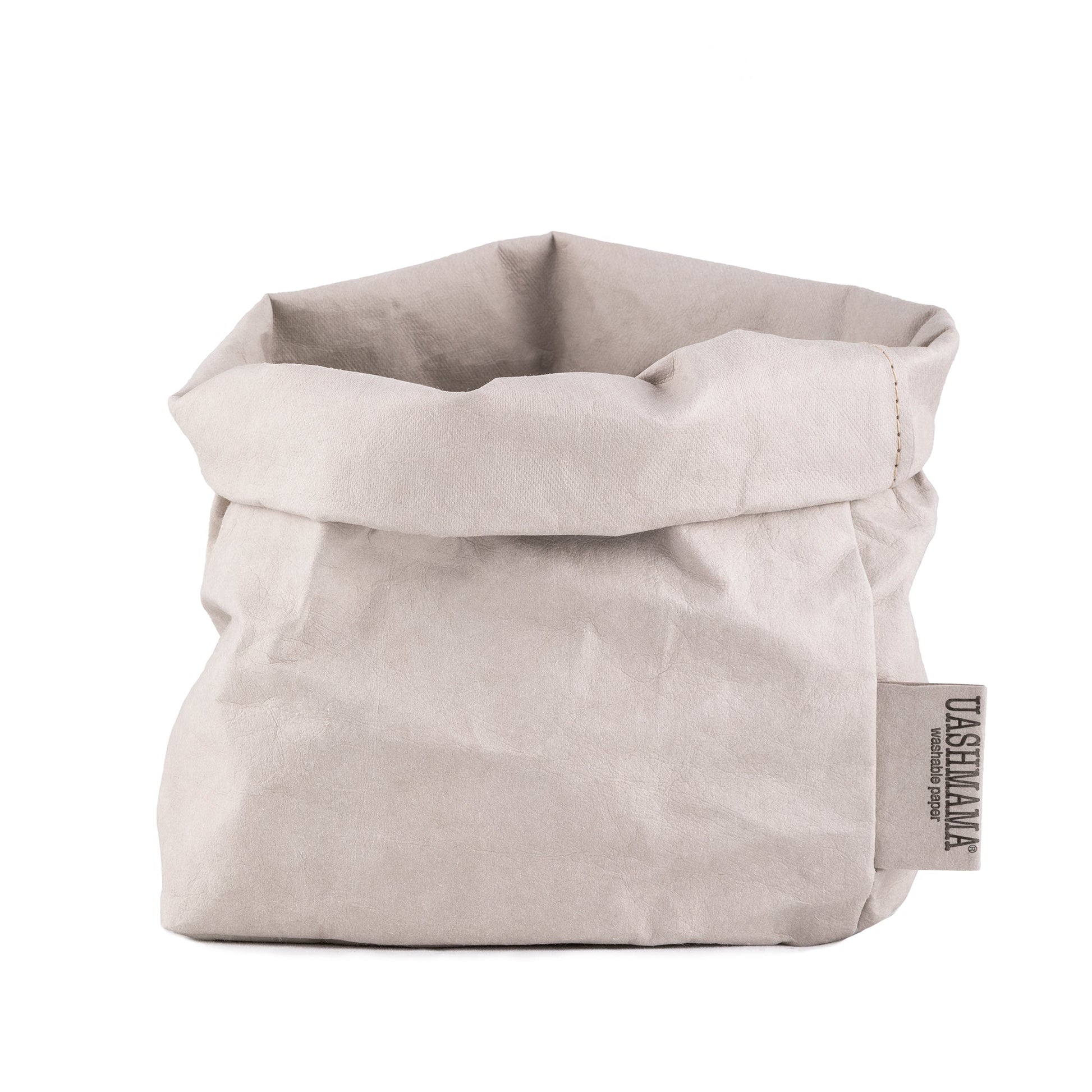 A washable paper bag is shown. The bag is rolled down at the top and features a UASHMAMA logo label on the bottom left corner. The bag pictured is the medium size in pale grey.