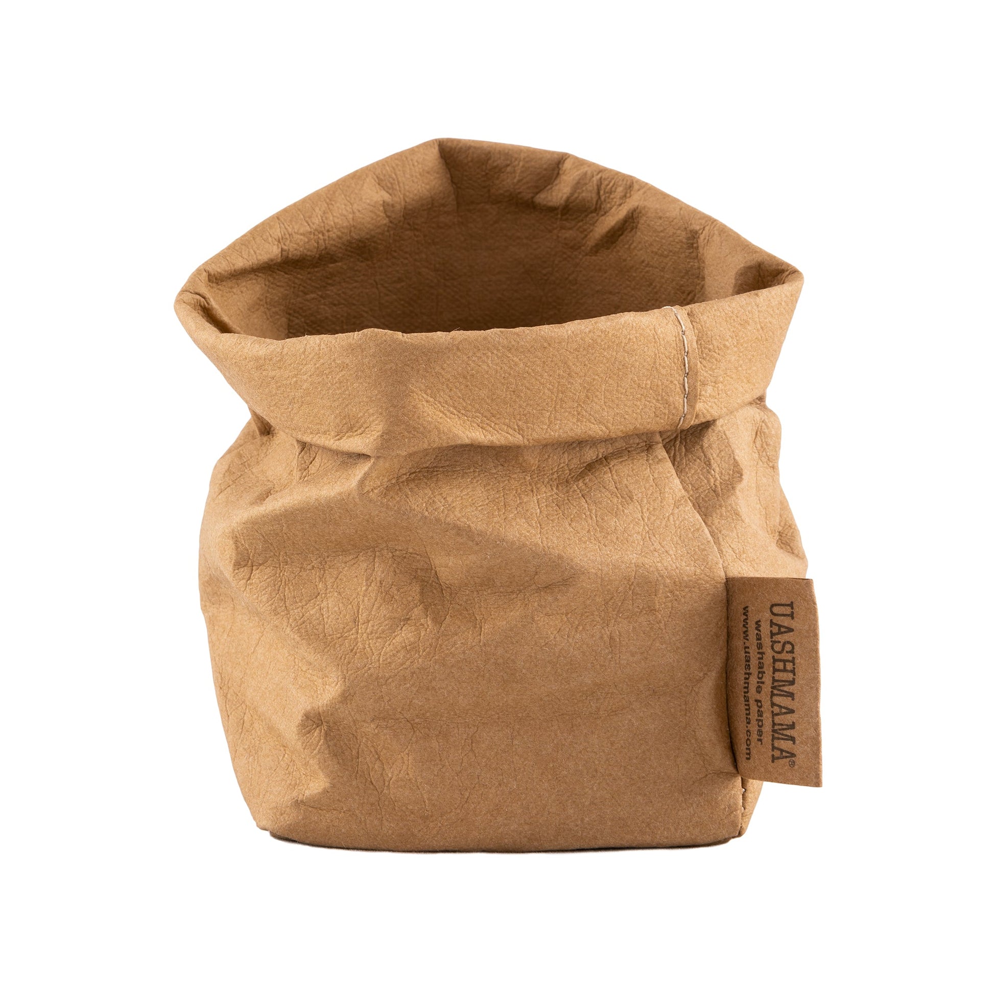 A washable paper bag is shown. The bag is rolled down at the top and features a UASHMAMA logo label on the bottom left corner. The bag pictured is the piccolo size in tan.