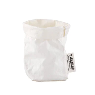 A washable paper bag is shown. The bag is rolled down at the top and features a UASHMAMA logo label on the bottom left corner. The bag pictured is the extra small size in white.