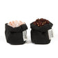 Two extra small washable paper bags both in black are shown. They contain pink rock salt, and black peppercorns.
