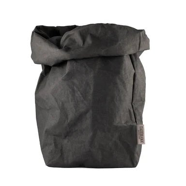 A washable paper bag is shown. The bag is rolled down at the top and features a UASHMAMA logo label on the bottom left corner. The bag pictured is the extra extra large size in dark grey.