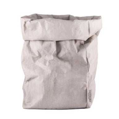 A washable paper bag is shown. The bag is rolled down at the top and features a UASHMAMA logo label on the bottom left corner. The bag pictured is the extra extra large size in pale grey.