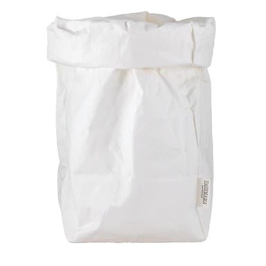A washable paper bag is shown. The bag is rolled down at the top and features a UASHMAMA logo label on the bottom left corner. The bag pictured is the extra extra large size in white.