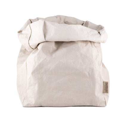 A washable paper bag is shown. The bag is rolled down at the top and features a UASHMAMA logo label on the bottom left corner. The bag pictured is the gigantic size in pale cream.