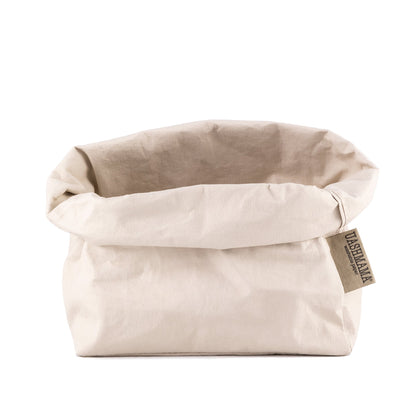 A washable paper bag is shown. The bag is rolled down at the top and features a UASHMAMA logo label on the bottom left corner. The bag pictured is the large size in cream.