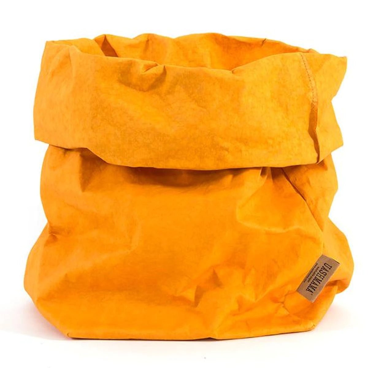 A washable paper bag is shown. The bag is rolled down at the top and features a UASHMAMA logo label on the bottom left corner. The bag pictured is the extra large size in yellow.