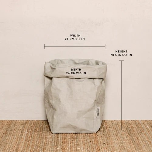 A washable paper bag is shown. The bag is rolled down at the top and features a UASHMAMA logo label on the bottom left corner. The bag pictured is the extra large size in light grey. The dimensions are shown on the image.