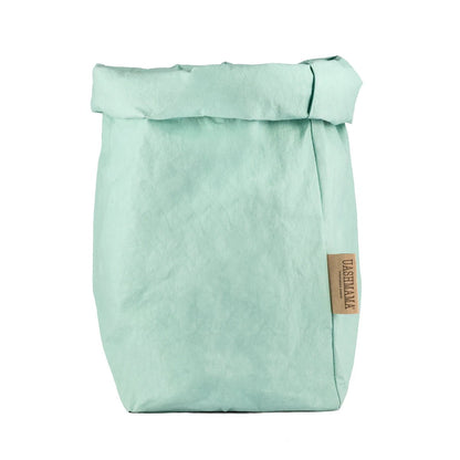 A washable paper bag is shown. The bag is rolled down at the top and features a UASHMAMA logo label on the bottom left corner. The bag pictured is the extra large size in pale turquoise.