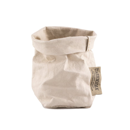 A washable paper bag is shown. The bag is rolled down at the top and features a UASHMAMA logo label on the bottom left corner. The bag pictured is the extra small size in a cream colour.
