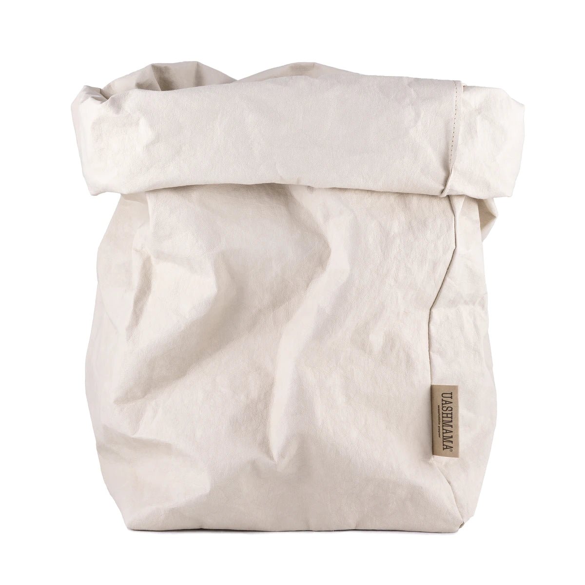 A washable paper bag is shown. The bag is rolled down at the top and features a UASHMAMA logo label on the bottom left corner. The bag pictured is the extra extra large size in a pale cream colour.