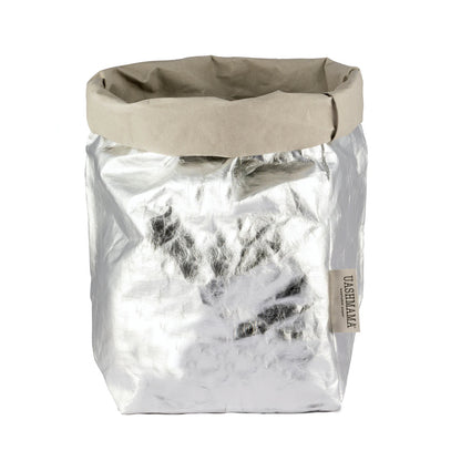 A washable paper bag is shown. The bag is rolled down at the top and features a UASHMAMA logo label on the bottom left corner. The bag pictured is the extra large size in metallic silver.