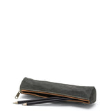 A washable paper pencil case is shown on its side with two pencils spilling out. The pencil case is black in colour and has a metal zip closure.