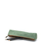 A washable paper pencil case is shown on its side with two pencils spilling out. The pencil case is sage green in colour and has a metal zip closure.