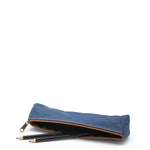 A washable paper pencil case is shown on its side with two pencils spilling out. The pencil case is blue in colour and has a metal zip closure.