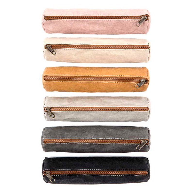 A selection of coloured washable paper pencil cases are shown lined up from top to bottom and shown from above. The colours shown in order from the top down are pale pink, cream, tan, light grey, dark grey and black. All pencil cases have their zips closed.
