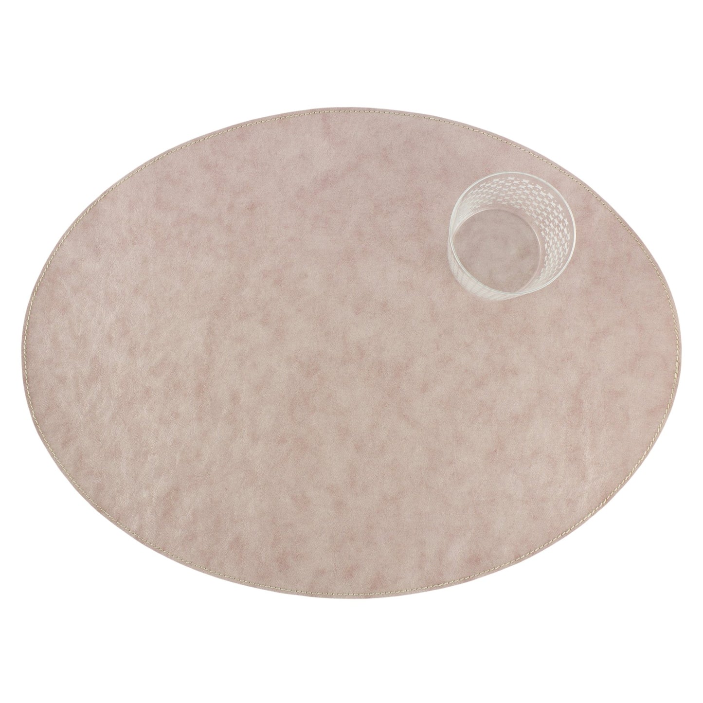 An oval washable paper placemats is shown with a small drinking glass in the upper right hand corner. The placemat shown is pale pink.