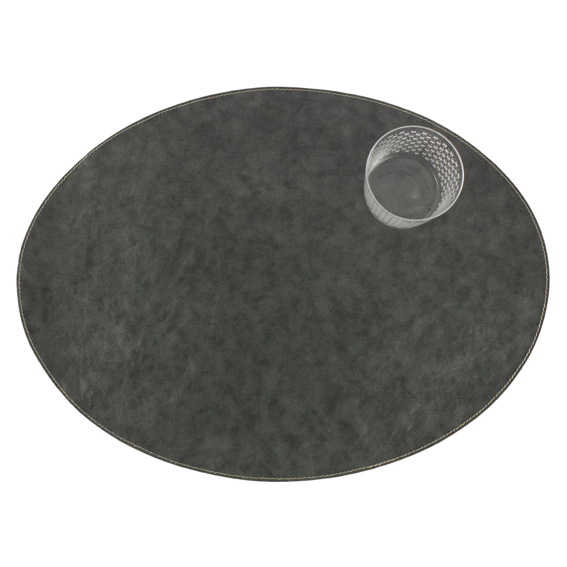 An oval washable paper placemats is shown with a small drinking glass in the upper right hand corner. The placemat shown is dark grey.