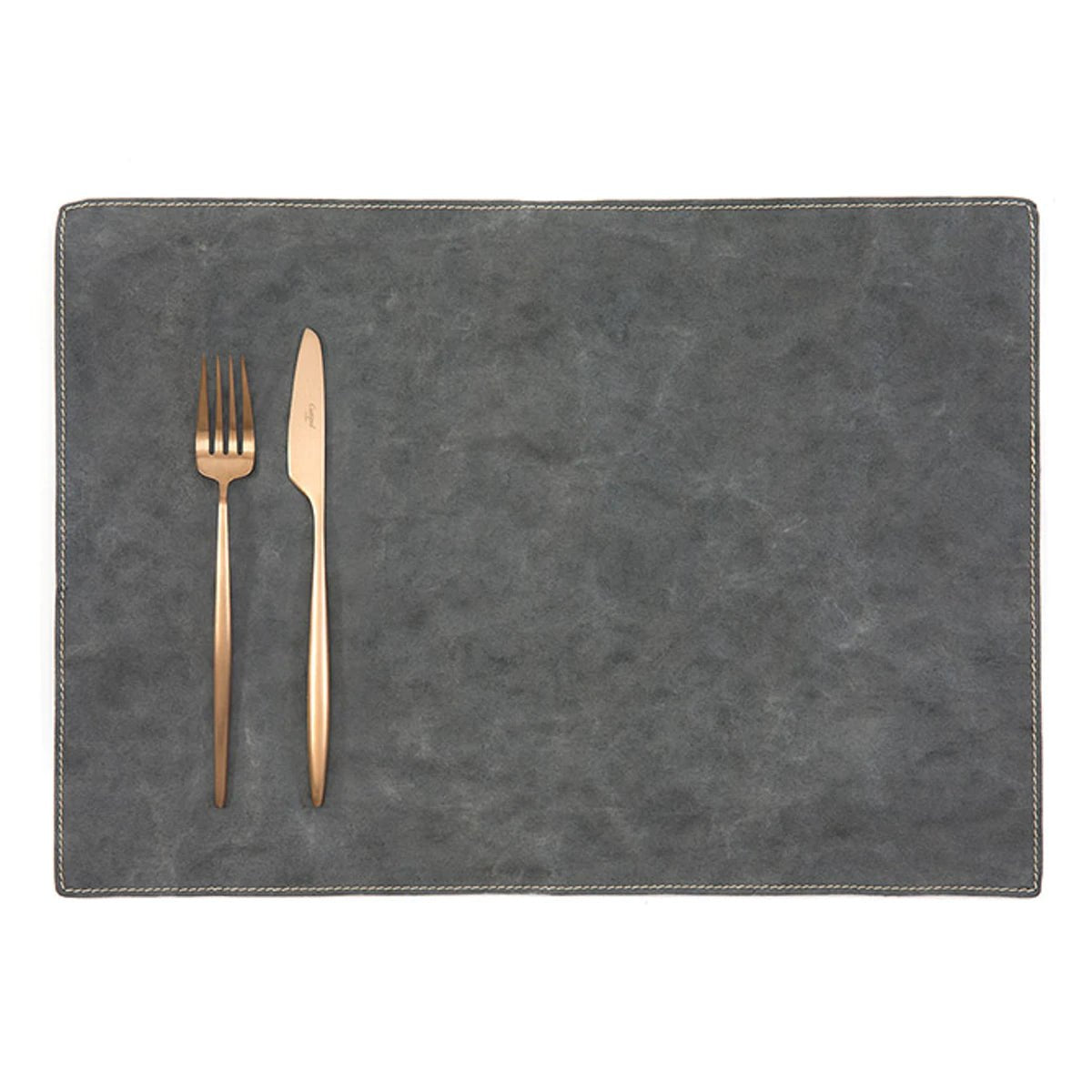 A rectangular washable paper placemat is shown with a rose gold fork and knife set on the left hand side. The placemat is dark grey.
