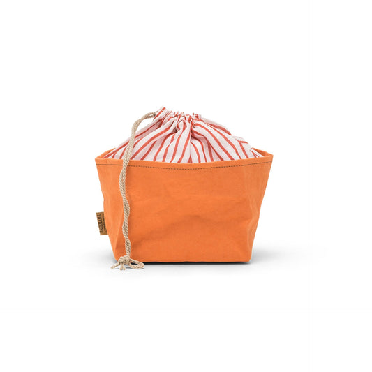 A washable paper bread bag with a drawstring organic linen top is shown. The bag has a small UASHMAMA logo label on the left hand side and fastens with a beige cord drawstring. The bag is orange in colour with an orange and white cotton drawstring top.