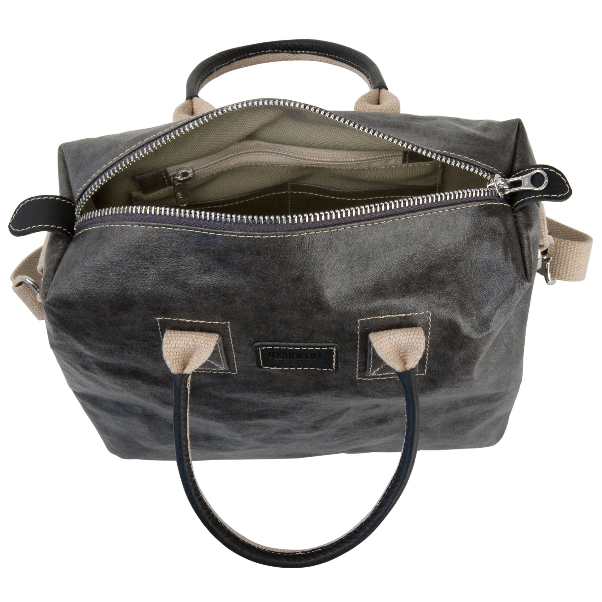 A small washable paper holdall is shown from above with the zip open. This shows an internal zipped pocket, two smaller pockets and organic cotton lining. The bag has two recycled cotton carry handles and a recycled cotton shoulder strap. The bag shown is dark grey.