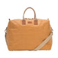 A washable paper holdall with two short carry handles and one long fabric strap. The holdall closes with a zip which has leather zip pulls. The holdall has leather details attaching the straps to the bag and a small UASHMAMA leather logo label. The bag shown is tan with tan leather details. The holdall is extra large in size.