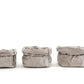 A small, medium and large paper bag in pale grey are lined up in size order from small to large.