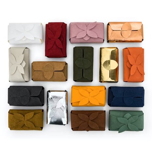 An assortment of washable paper soap holders are shown in various colours. 