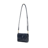 A small woven washable paper handbag is shown. The bag has a front flap closure and a washable paper strap attached to the bag by metal clips. The bag is shown in dark blue.