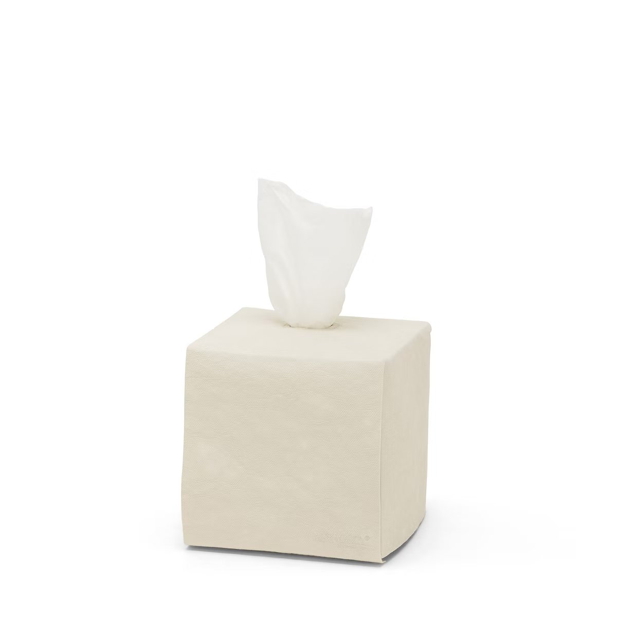 A square tissue box holder made of washable paper is shown, with a white tissue protruding from the top of the box. The UASHMAMA logo is printed in white lettering on the bottom right hand corner of the box. The tissue box cover is pale cream.