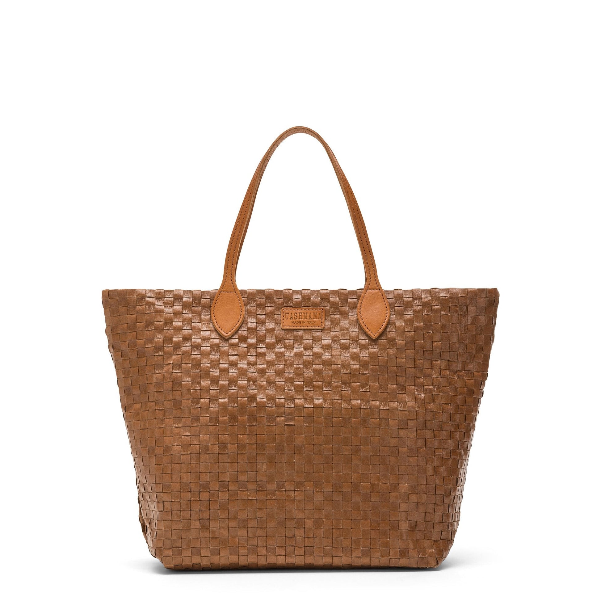 A large washable paper woven tote is shown. It has two long tan leather handles and a tan leather UASHMAMA logo label on the outside in between the handles. The bag shown is in a dark tan colour.