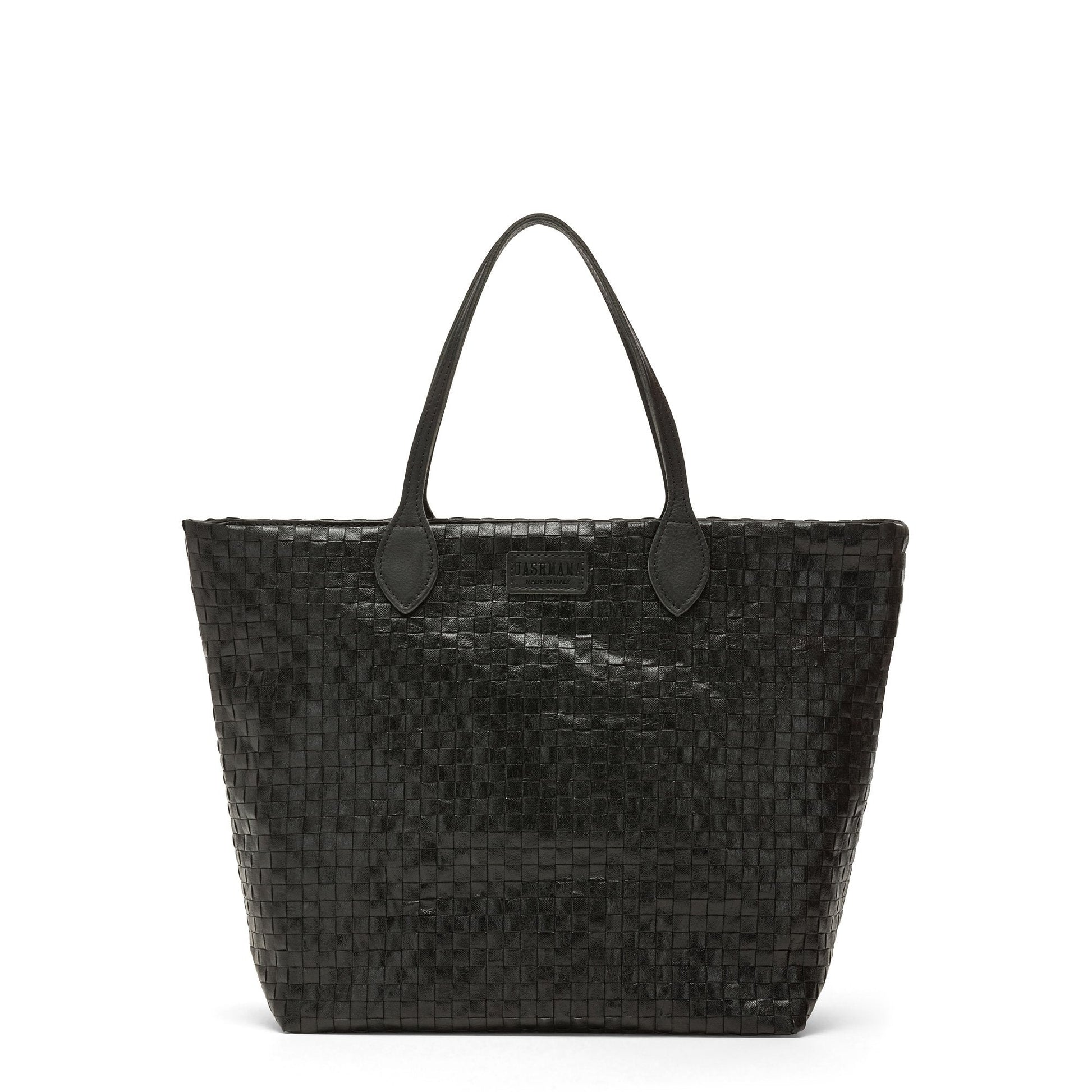 A large washable paper woven tote is shown. It has two long leather handles and a leather UASHMAMA logo label on the outside in between the handles. The bag shown is black.