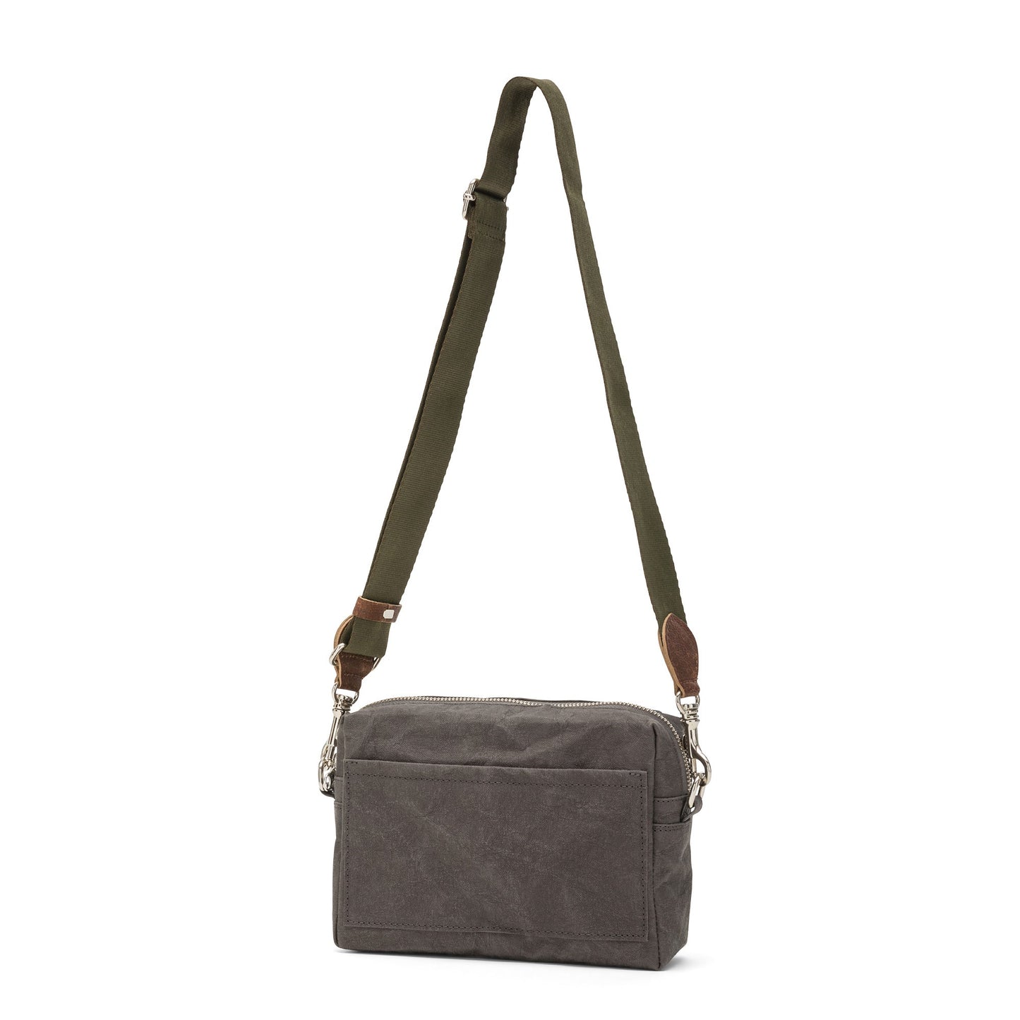 A rectangular washable paper handbag with an external side pocket is shown. The bag has a canvas strap, washable paper details and metal fastening clips to attach the straps to the bag. The bag closes by a zip. The bag shown is dark grey with an olive strap.
