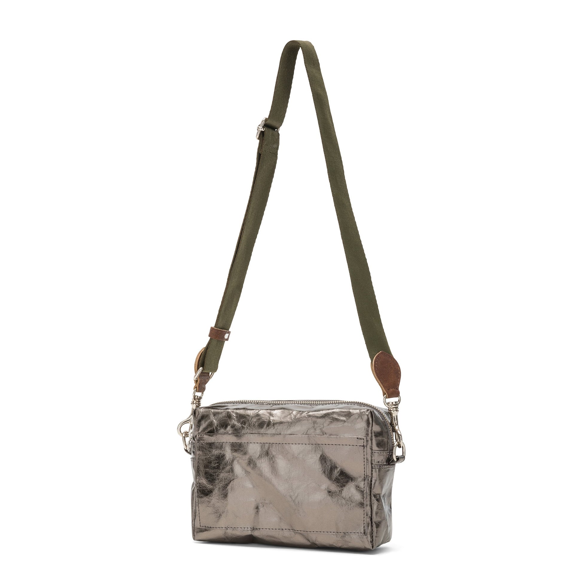 A rectangular washable paper handbag with an external side pocket is shown. The bag has a canvas strap, washable paper details and metal fastening clips to attach the straps to the bag. The bag closes by a zip. The bag shown is metallic dark grey with an olive strap.