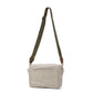 A rectangular washable paper handbag with an external side pocket is shown. The bag has a canvas strap, washable paper details and metal fastening clips to attach the straps to the bag. The bag closes by a zip. The bag shown is light grey with an olive strap.