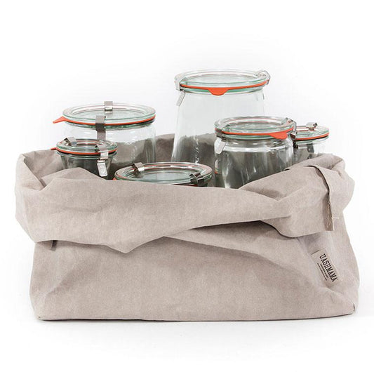 A pale grey washable paper tray is shown with the top rolled down. The tray contains 4 glass jars of varying height. The UASHMAMA logo label is visible on the lower right corner of the tray.