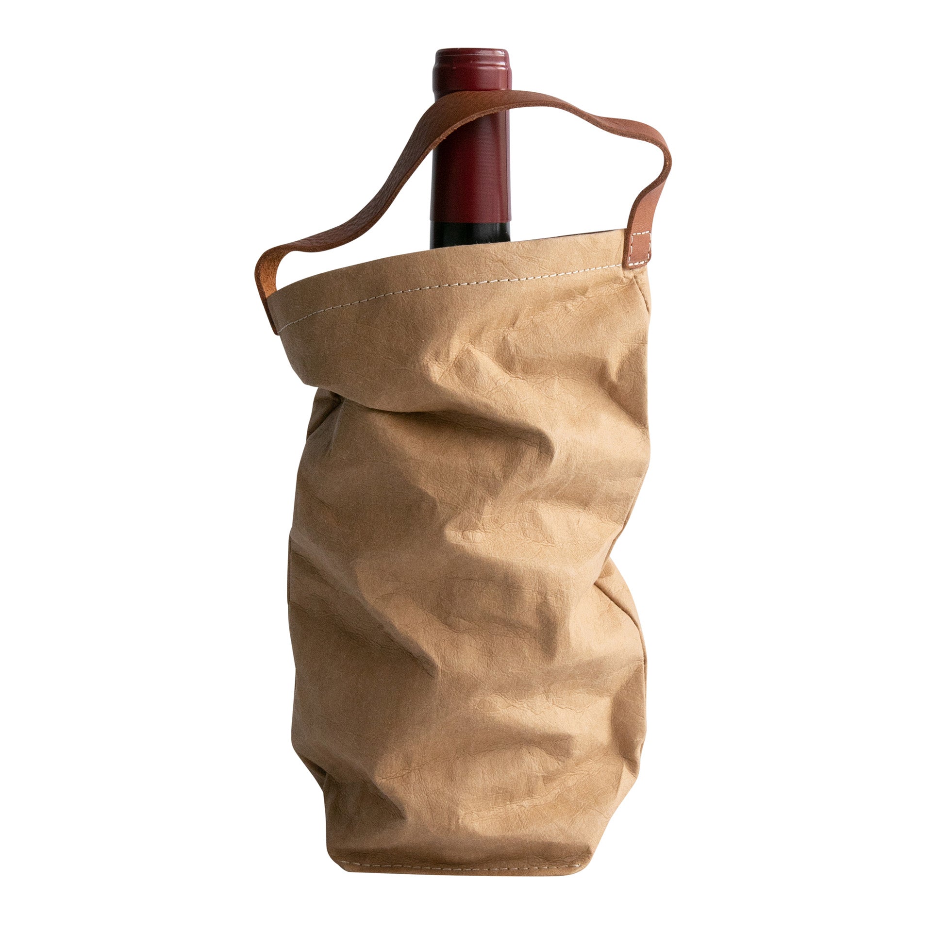 A red wine bottle is shown inside a washable paper wine bag. The bag has a small brown leather handle at the top for carrying. The washable paper wine bag shown is light tan.