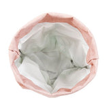 A top down view shows the bottle cooler inside a pink washable paper wine bag.